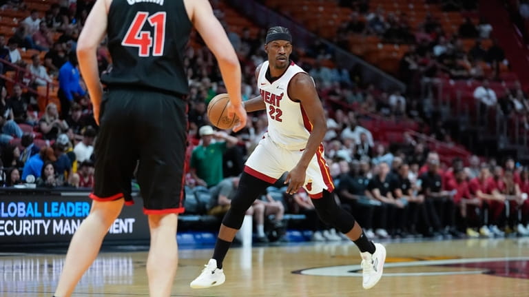 Miami Heat forward Jimmy Butler (22) looks for an opening...