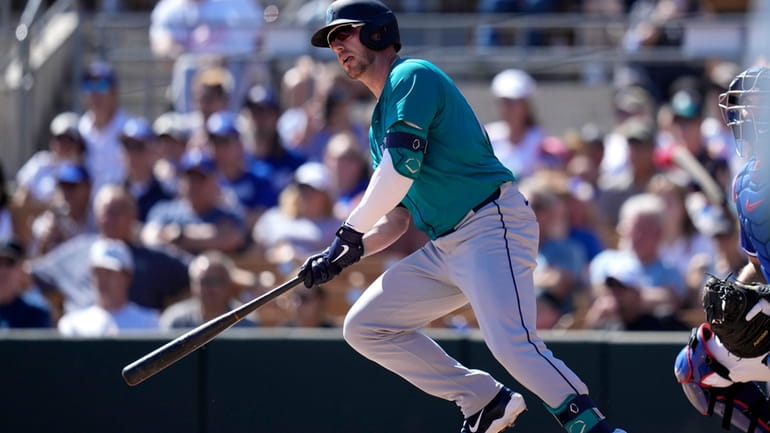 Seattle Mariners' Mitch Garver watches his two-run double against the...