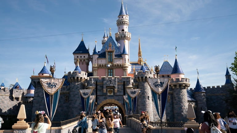 Visitors pass through Disneyland in Anaheim, Calif., April 30, 2021.