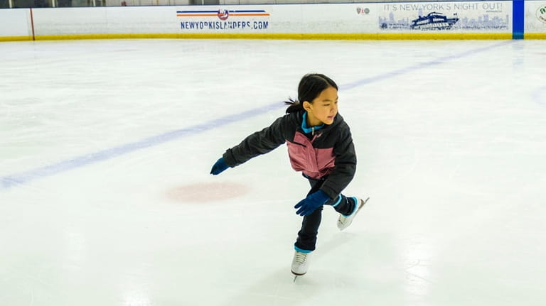 Ansley Teng, 9, of Garden City practices her figure skating...