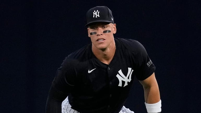 Yankees centerfielder Aaron Judge stretches before a spring training baseball...