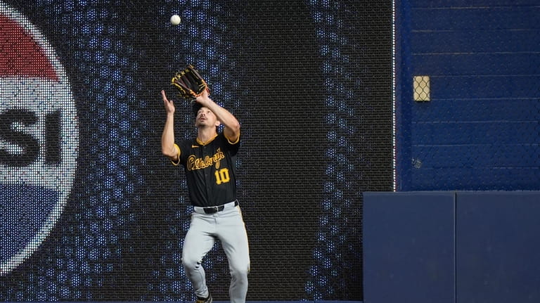 Pittsburgh Pirates right fielder Bryan Reynolds catches a ball hit...