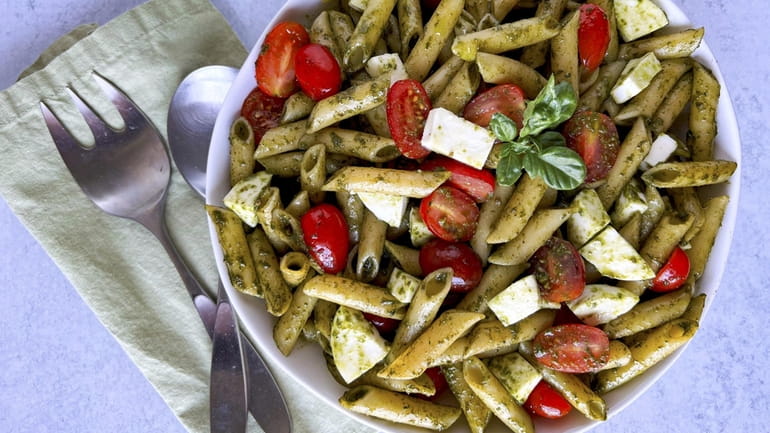 A simple basil blender sauce tossed with pasta, fresh mozzarella,...