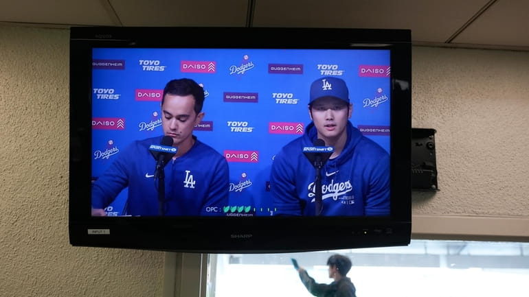 A video screen displays Los Angeles Dodgers' Shohei Ohtani, right,...