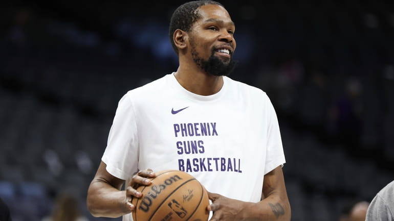 Phoenix Suns forward Kevin Durant gestures during warmups before an...