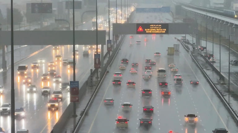 Vehicles drive through heavy rain on the Sheikh Zayed Road...