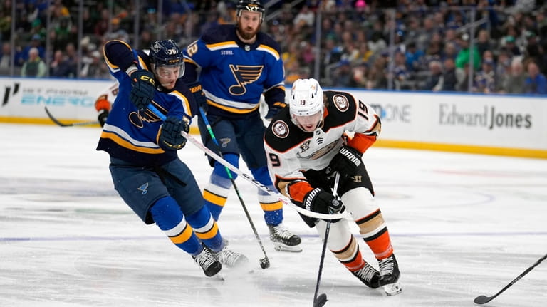 Anaheim Ducks' Troy Terry (19) and St. Louis Blues' Zack...