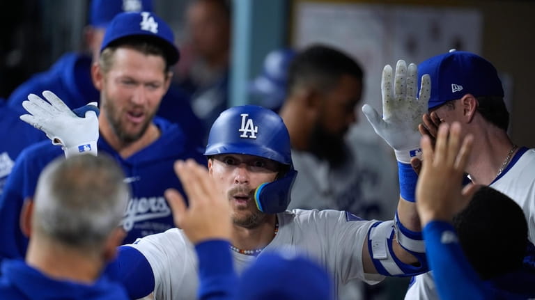 Los Angeles Dodgers' Kiké Hernández celebrates with teammates after hitting...