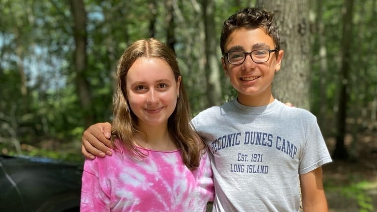 Ellie Wolf, 15, and her brother, Nate, 13, both attend...