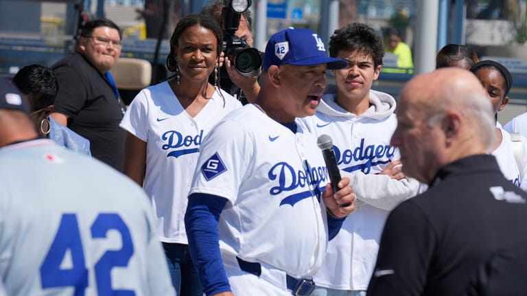Los Angeles Dodgers manager Dave Roberts, center, introduces Ayo Robinson,...