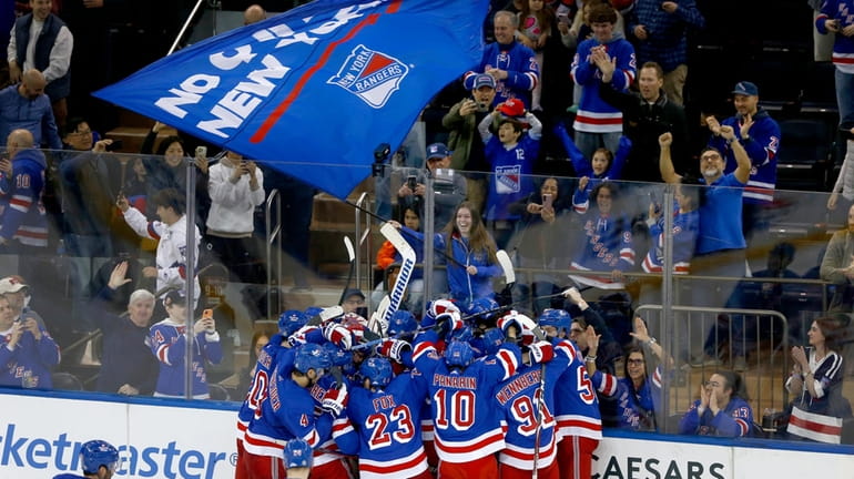 The Rangers and fans celebrate a shootout victory over the...