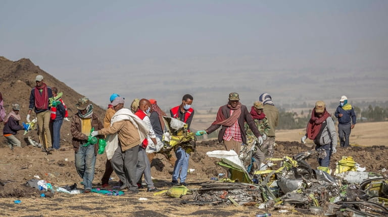 Rescuers work at the scene of an Ethiopian Airlines flight...