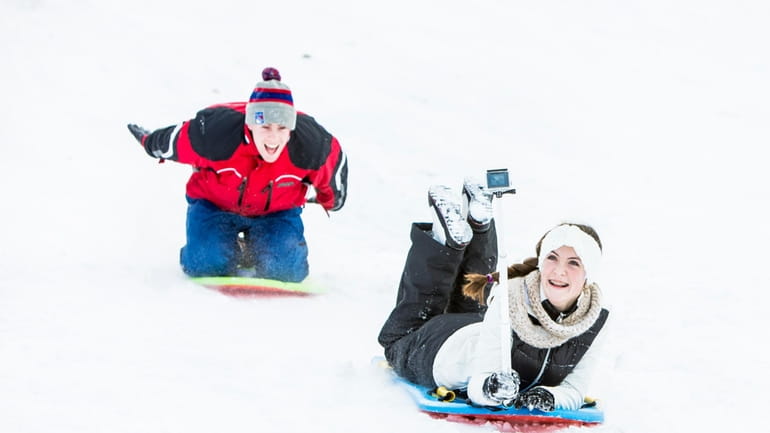 Shannon Creagh, and her brother Liam Creagh, sled down the...