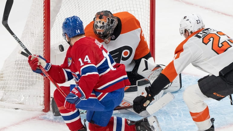 Montreal Canadiens' Nick Suzuki (14) scores on Philadelphia Flyers goaltender...