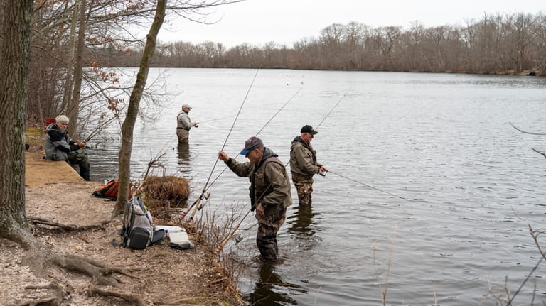 People fishing for brown trout at Twin Lakes Preserve in...