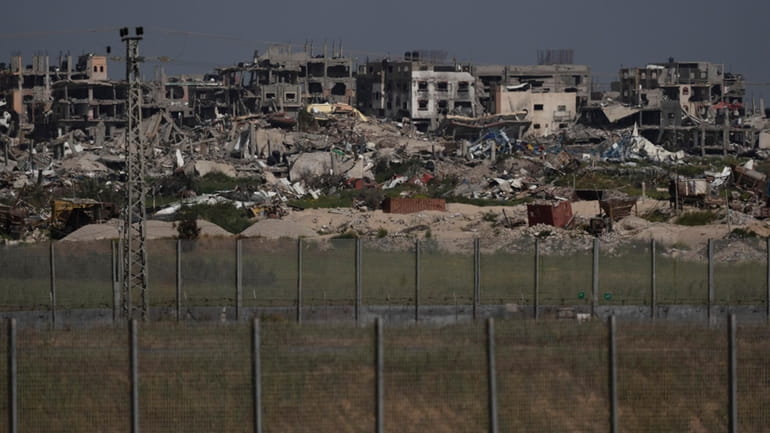 Destroyed buildings stand in the Gaza Strip as seen from...