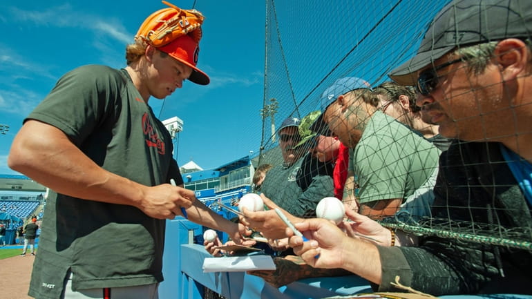 Baltimore Orioles second baseman Jackson Holliday signs autographs before a...