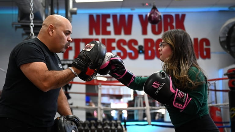 Alexia Rivera, 20, of Huntington Station trains with her dad,...