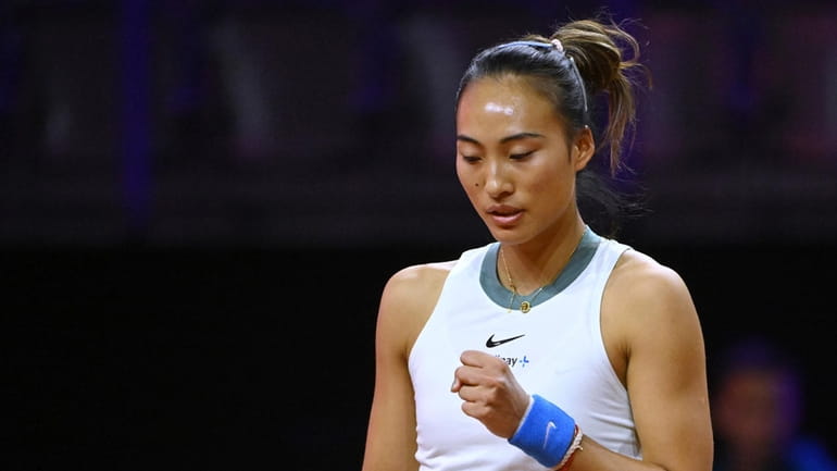China's Qinwen Zheng raises a fist during the Porsche Tennis...