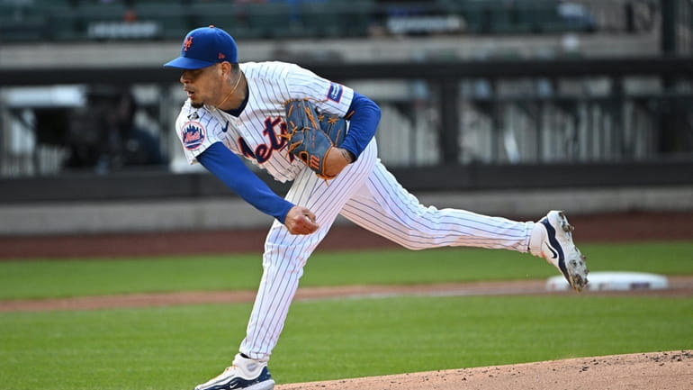 New York Mets starting pitcher Jose Butto delivers during the...