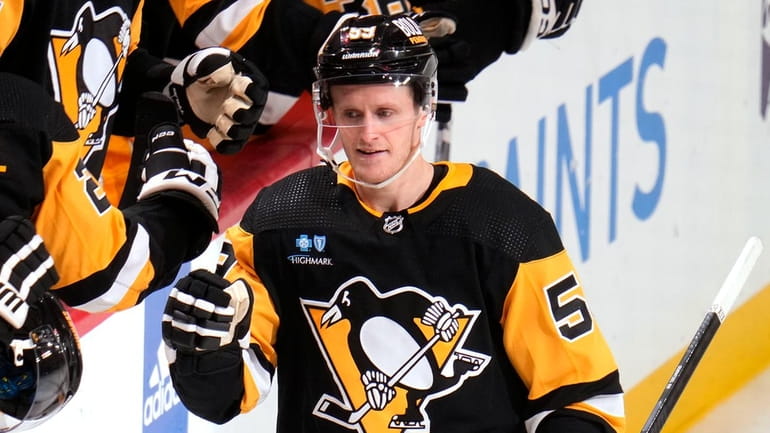 The Penguins' Jake Guentzel returns to the bench after scoring...