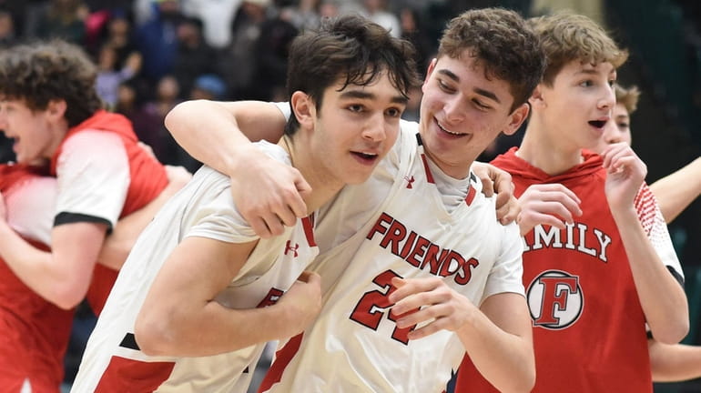 Friends Academy teammates celebrate their 61-60 win over Southampton in...