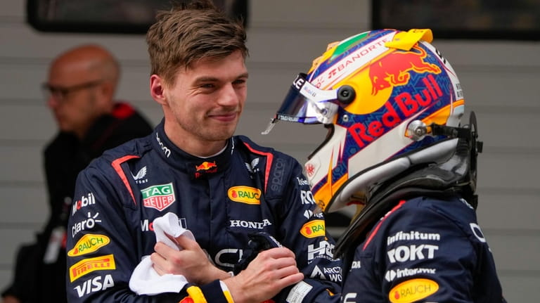 Red Bull driver Max Verstappen, left, of the Netherlands is...