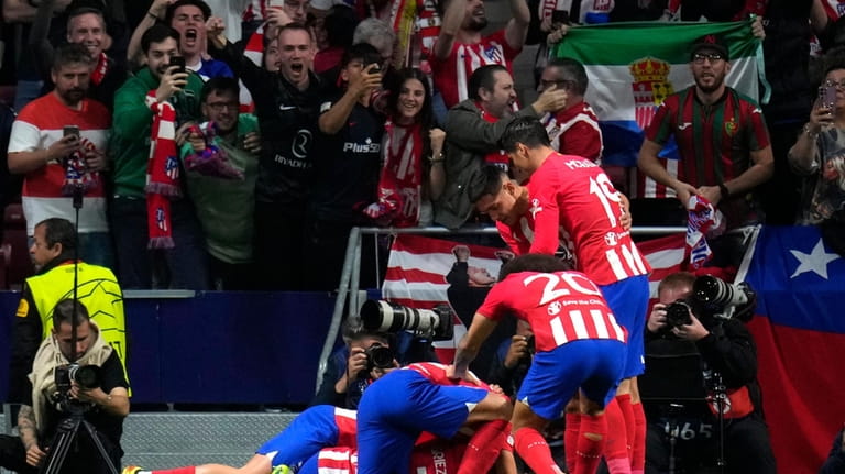 Atletico Madrid players celebrate after Atletico Madrid's Samuel Lino scored...