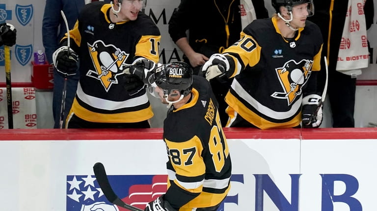 Pittsburgh Penguins' Sidney Crosby (87) returns to the bench after...