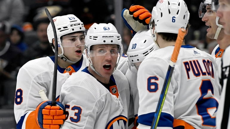 Islanders center Casey Cizikas (53) celebrates with teammates after scoring...