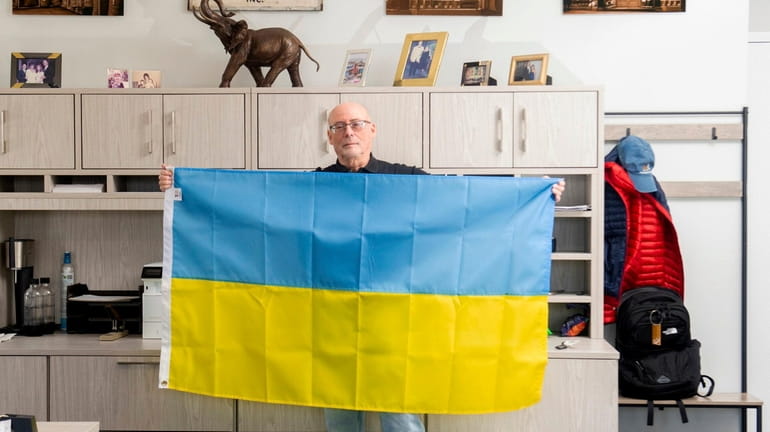 Roy Glaser of Glaser Mills poses with the Ukrainian flag at...