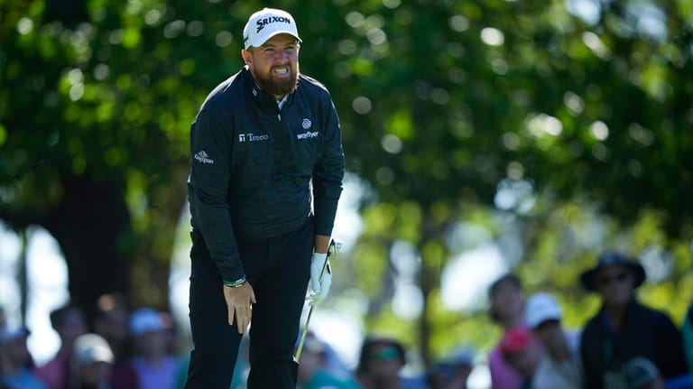 Shane Lowry, of Ireland, watches his tee shot on the...