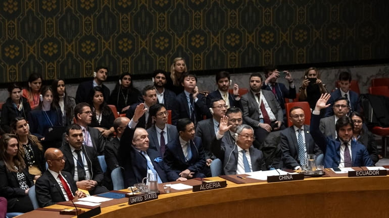 Representatives of member countries take votes during a Security Council...
