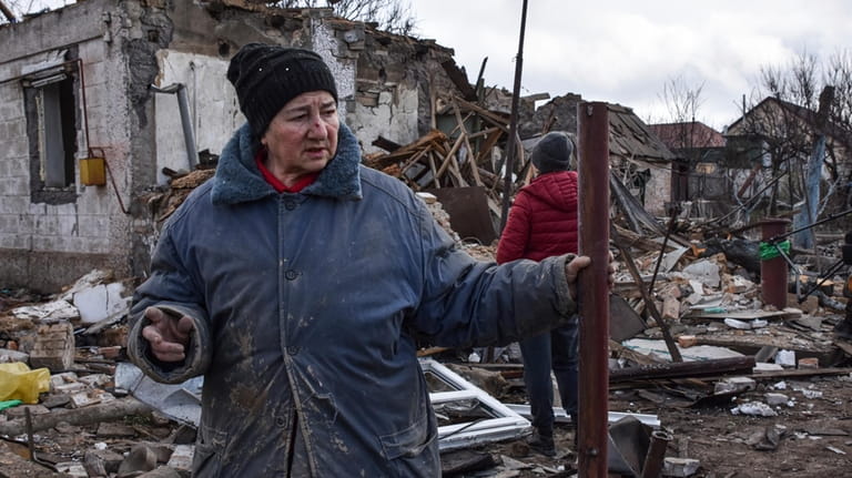 Inna, 71, stands outside of her house which was destroyed...