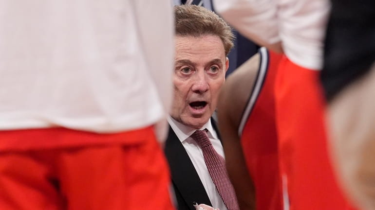 St. John's coach Rick Pitino talks to players during a...