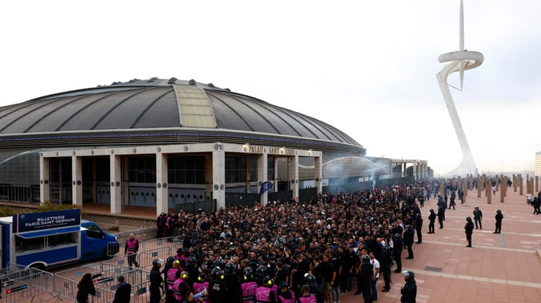 Paris Saint-Germain supporters arrive at the Olimpic Lluis Companys stadium...