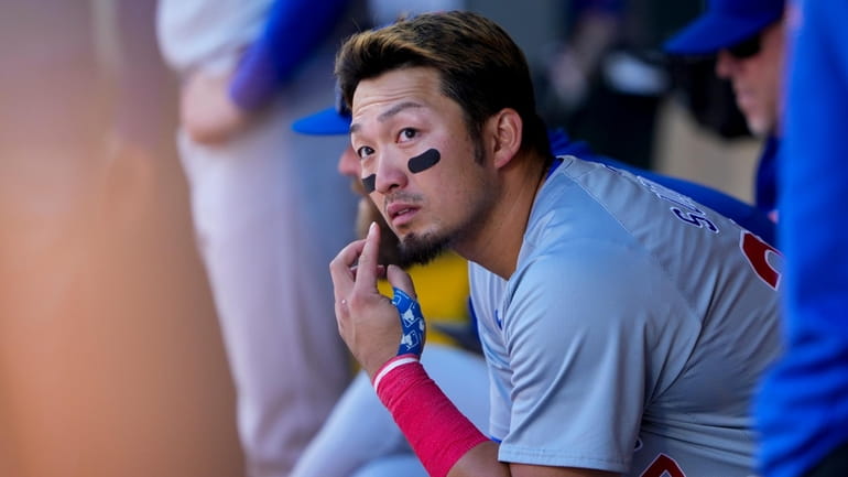 Chicago Cubs designated hitter Seiya Suzuki sits in the dugout...