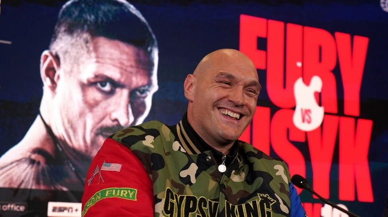 British professional boxer Tyson Fury smiles during a news conference...
