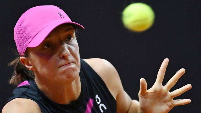 Poland's Iga Swiatek plays Britain's Emma Raducanu during her quarterfinals...
