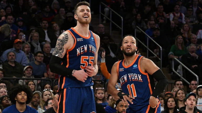 Knicks guard Jalen Brunson and center Isaiah Hartenstein watch as...