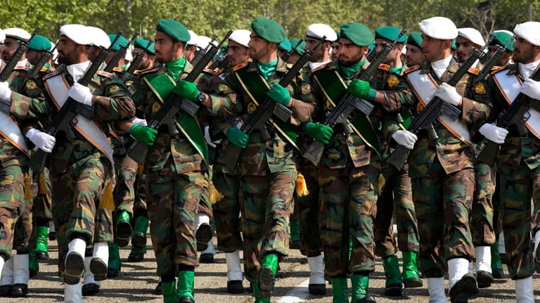 Iranian army members march during Army Day parade at a...