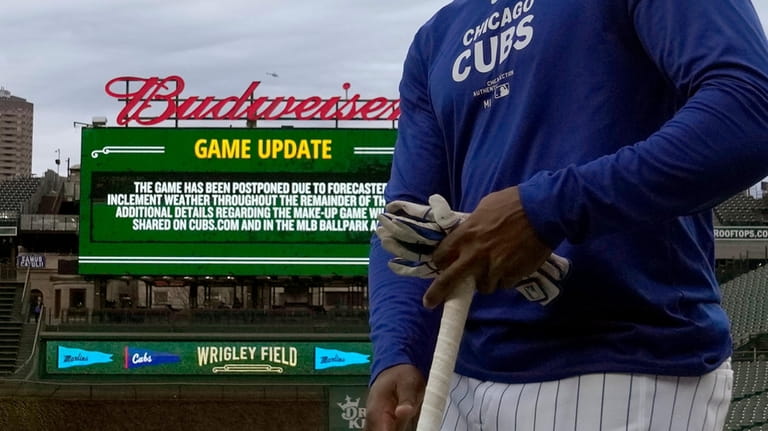 Chicago Cubs' Alexander Canario walks to the dugout after batting...