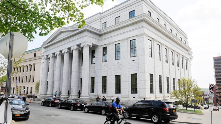 A cyclist rides past the New York Court of Appeals,...