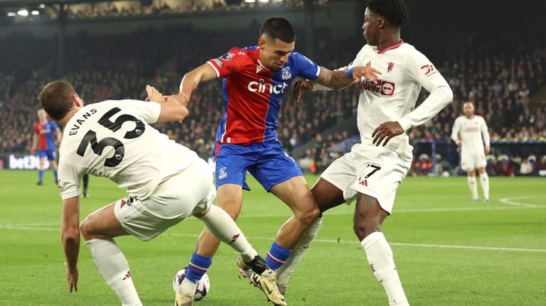 Crystal Palace's Daniel Munoz, centre, challenges for the ball with...