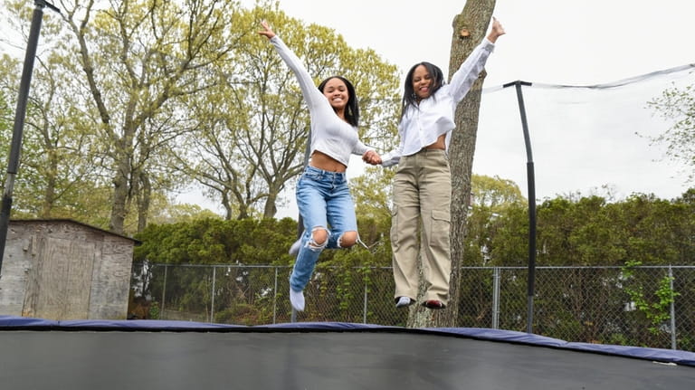 Mariah Brand jumps on the trampoline with her mother, Janet,...