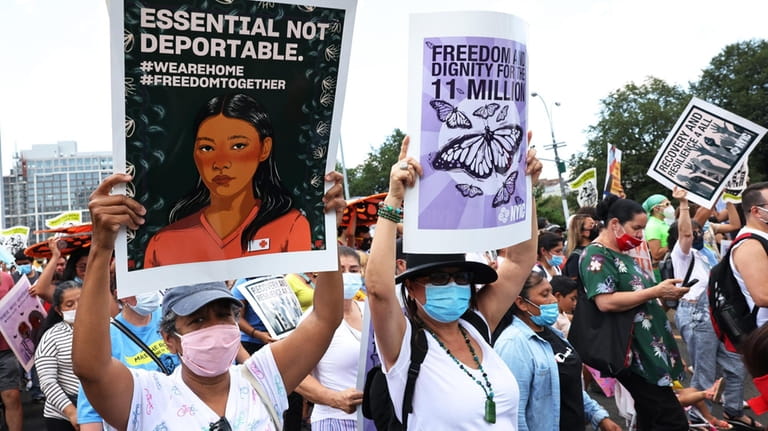 Protesters participate in a march in support of a pathway...