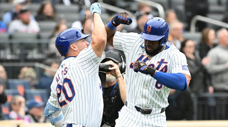 The Mets’ Pete Alonso greets designated hitter Starling Marte after...