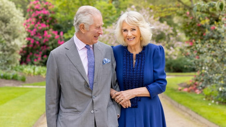 Britain's King Charles III and Queen Camilla stand in Buckingham...