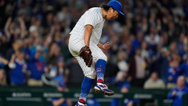 Chicago Cubs starting pitcher Shota Imanaga reacts to striking out...