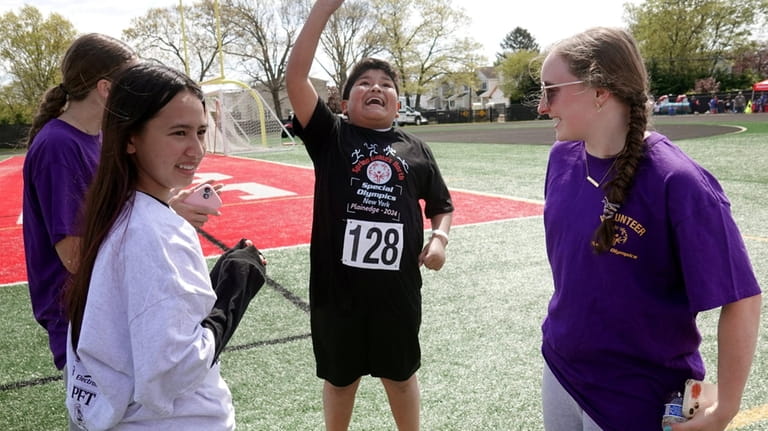 Special Olympics athlete Liam Enriquez, 9, of Islip, celebrates after winning...